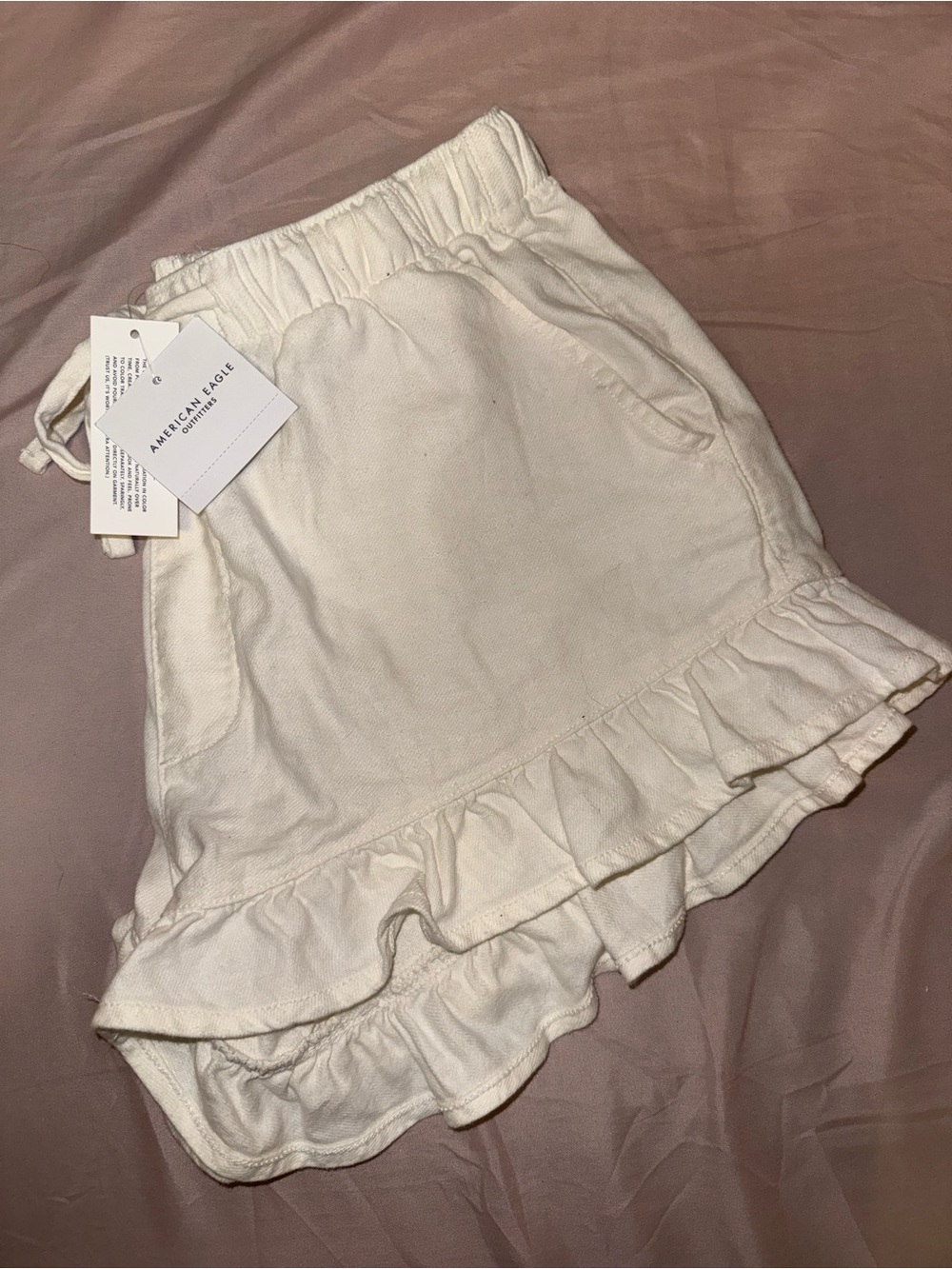 American Eagle Outfitters Cream Asymmetrical Ruffle Hem Shorts